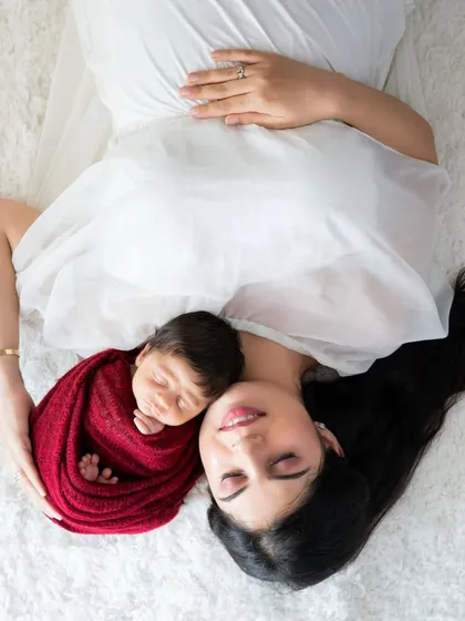 A creative pose with mom and baby. This image symbolizes the baby coming from the mother's womb, a beautiful and artistic representation of their connection.