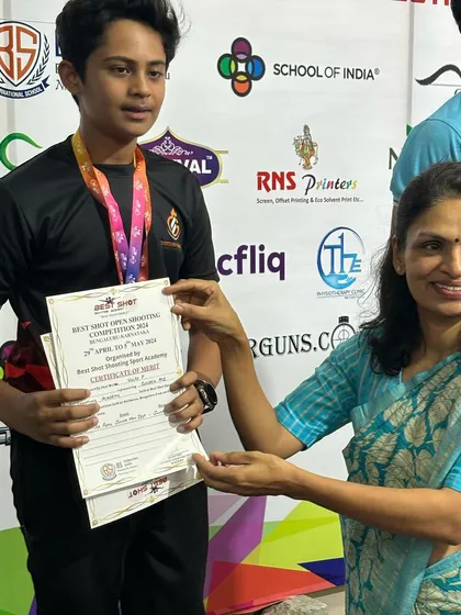 A student receives his certificate of merit during the award ceremony of the Best Shot Open Shooting Competition, a proud moment for him and the academy.