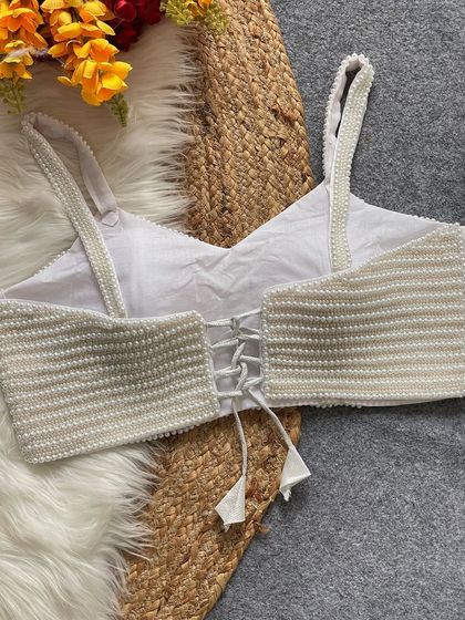 Another angle of the white pearl blouse's back, showing the quality of the pure silk lining.