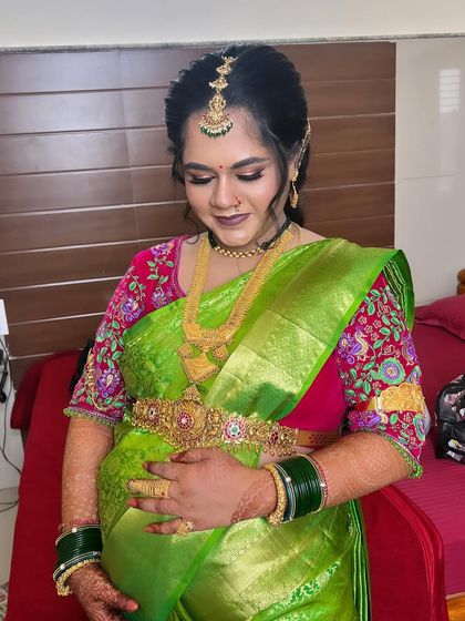 A glowing look for Gowthami's baby shower. We used soft makeup to enhance her features, paired with a bright green saree and traditional jewellery, making her look and feel beautiful.
