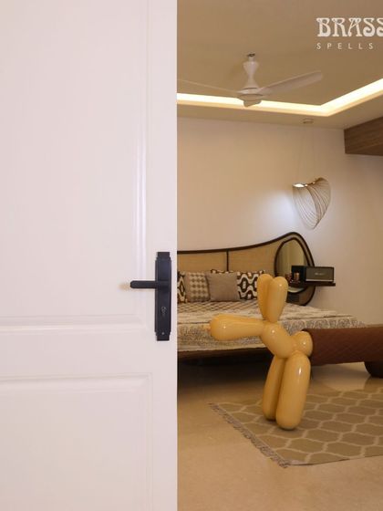 A glimpse into the bedroom, where the black Natali handle on the white door creates a chic and contemporary feel.