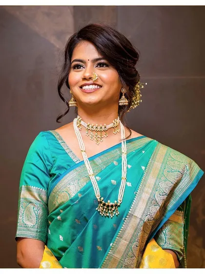 Ashlesha's wide smile says it all. Her wedding look was classic and elegant, with gold glitter eyes and a flawless base that looked beautiful both in person and on camera.