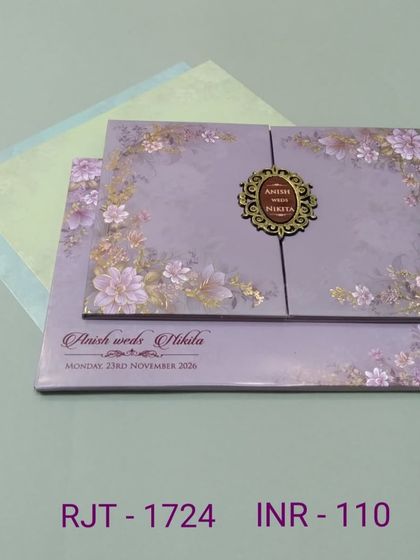 This lavender gate-fold card is decorated with a beautiful floral print and an ornate monogram. The design is soft, romantic, and includes two matching inserts.