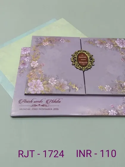 This lavender gate-fold card is decorated with a beautiful floral print and an ornate monogram. The design is soft, romantic, and includes two matching inserts.
