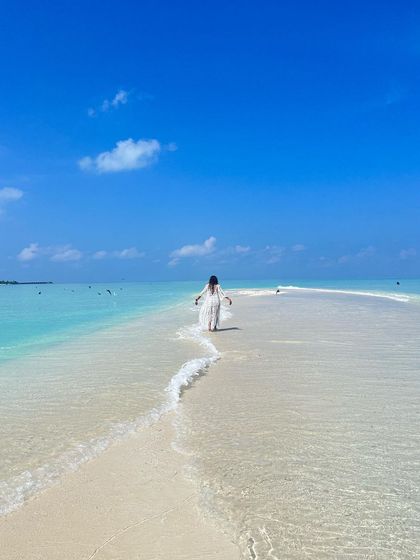 Walking along a beautiful sandbank in the Maldives, feeling completely connected to the elements of water and air.