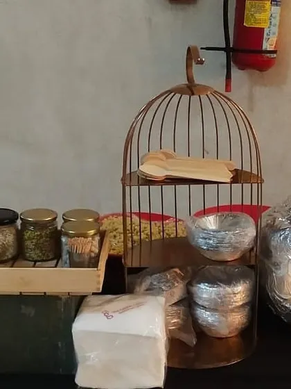 For a festive occasion like Ganesh Chaturthi, I created this themed drop-off setup. It includes decor elements like a birdcage stand and neatly packaged food items, adding a special touch to the celebration.