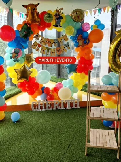 Gotta catch 'em all with this Pokemon birthday theme! A circular balloon arch in rainbow colors is decorated with Pikachu and other Pokemon characters.
