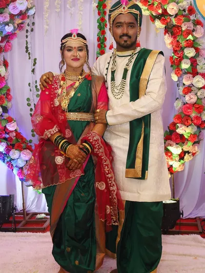 A classic portrait of the bride and groom. The bride's traditional attire, complete with the mundavalya and nath, is a beautiful celebration of Maharashtrian culture.