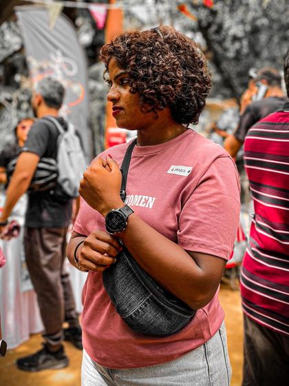 A candid portrait of a member at the Garage Sale, wearing our popular pink 'Spokes Women' T-shirt.