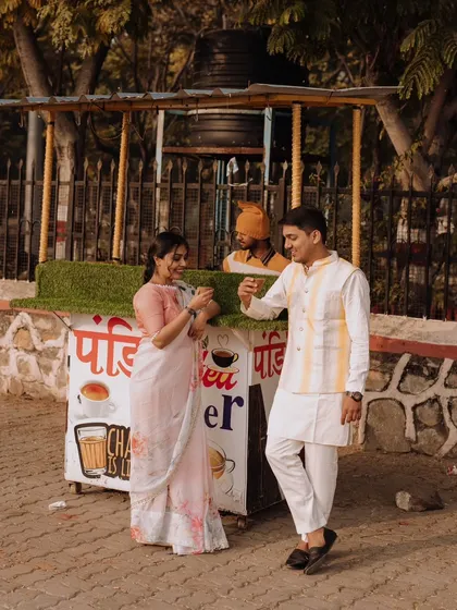 A fun and candid moment of the couple sharing a cup of chai from a local street vendor in Udaipur, capturing a slice of everyday life and love.