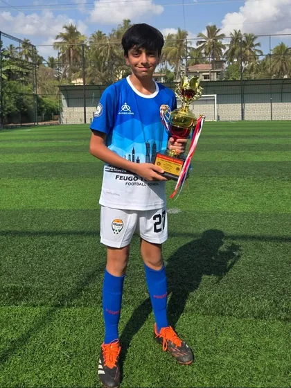 A member of the U14 Feugo Tigers team with his winner's trophy.