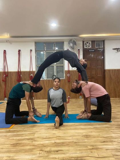 A creative and challenging acro yoga pose performed by our students, showcasing their strength, flexibility, and teamwork.