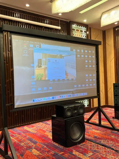 A look at the complete audio-visual setup used during our training workshops. We utilize high-quality projectors, screens, and a full range of speakers and subwoofers to create a comprehensive learning and demonstration environment.