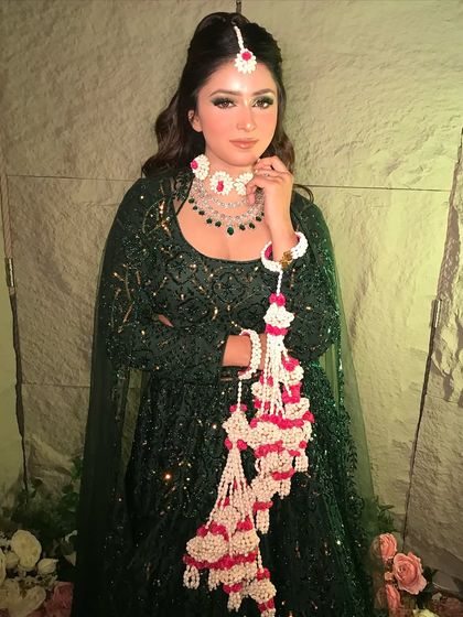 A full view of the emerald green Mehendi outfit, complete with stunning floral kaleeras that add a traditional yet modern touch.