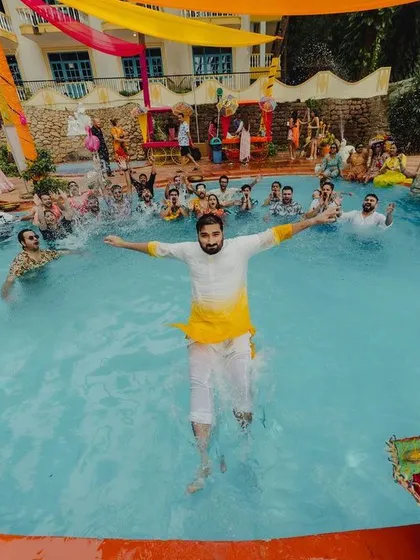 A wedding isn't just about ceremonies; it's about having the time of your life. This groom taking a joyful leap into the pool captures the spirit of the fun-filled Haldi carnival I planned in Goa.