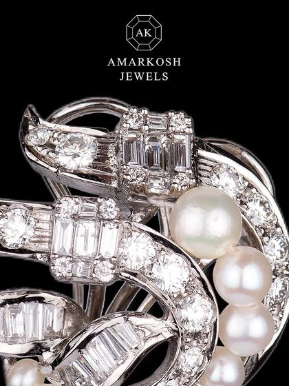 These breathtaking earrings feature an intricate design of natural round diamonds, baguette diamonds, and natural pearls, embodying luxury and elegance.