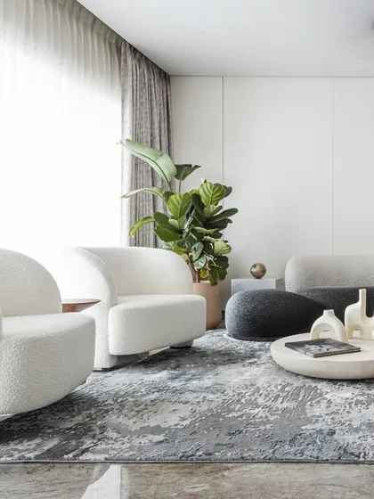 This living room is a space where form meets flow, and every curve invites connection. We designed this room to make a statement without saying a word, using bold, sculptural furniture in a sleek black-and-white palette to anchor the space. It creates a dynamic yet inviting hub for social moments, embodying our belief in quiet luxury.