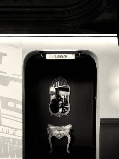 Another perspective of the washroom entrance at Jollygunj. The arched doorway and classic furniture pieces were chosen to evoke the nostalgic, joyful vibe of old Calcutta.