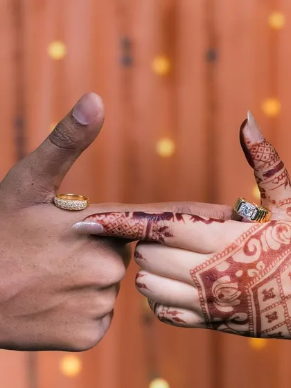 A creative shot of the couple's hands and rings.