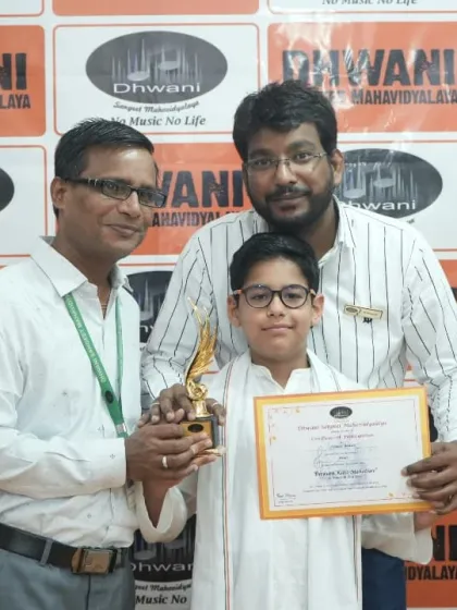 Our instructors presenting an award to a student in traditional attire.