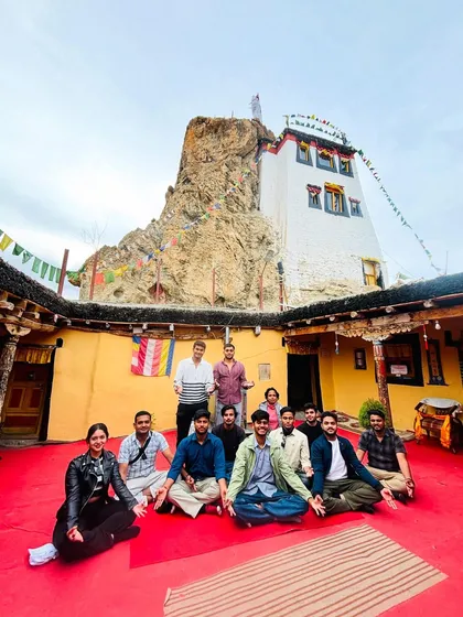 The group sitting together inside the courtyard of a Spiti monastery. These moments of quiet reflection and cultural immersion are what make the trip so special.