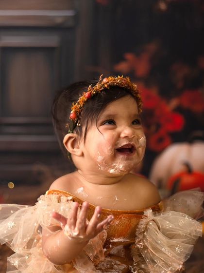 Pure joy and a face full of frosting. This little princess had the best time at her pumpkin and fall-themed cake smash session.