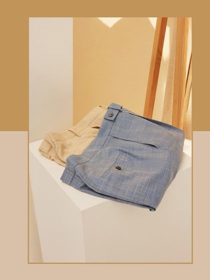 The foundation of a great summer wardrobe. This image showcases our light blue and beige custom trousers, crafted for those who believe in relaxation and self-care.