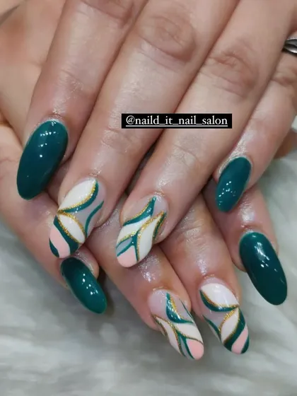 An artistic design in deep teal green. The accent nails feature a beautiful hand-painted abstract floral pattern using negative space, pink, and gold lines.