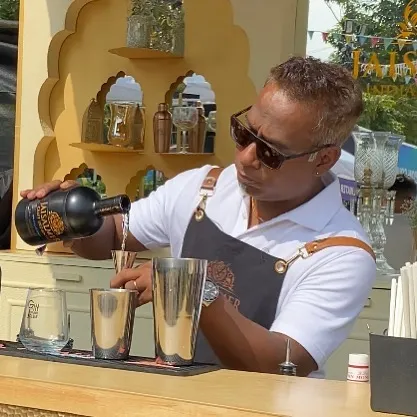 Here I am crafting a signature gin cocktail at an outdoor brand event. My mobile bar service is fully equipped to handle any setting, from large corporate launches to intimate garden parties, ensuring a professional setup every time.