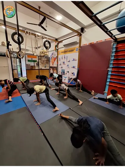 A class works on achieving splits and other deep stretches. Consistent practice with proper guidance is the key to unlocking your body's flexibility.