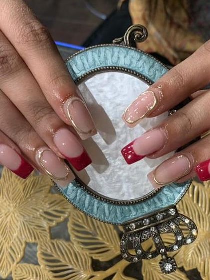 A sophisticated set of square-shaped extensions with red French tips and a delicate gold chrome outline.