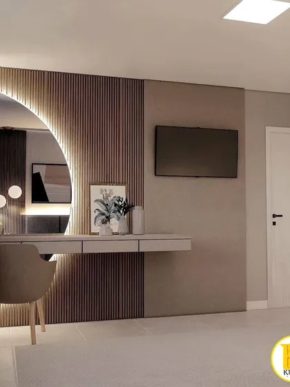 This view shows the integrated dressing table with a large, backlit semi-circular mirror, creating a glamorous and functional corner.