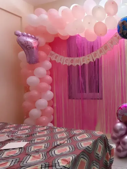 A sweet and simple "Welcome Home" decoration for a newborn baby girl. I transformed this bedroom with a pink and white balloon arch and a foil curtain backdrop to create a cozy and celebratory space.