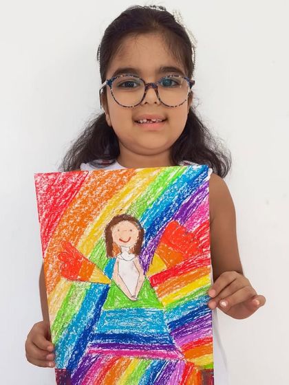 A joyful angel with rainbow wings. This piece is bursting with color and positive energy.