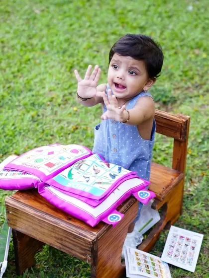 "No more books for today!" This playful shot from an outdoor session captures the fun and spontaneous moments of childhood.