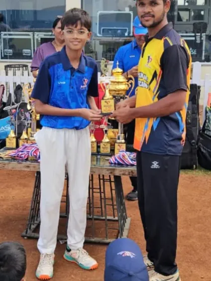 A player from the U-12/U-14 age group is presented with a trophy for his performance in the Pravin Tambe Premier League.