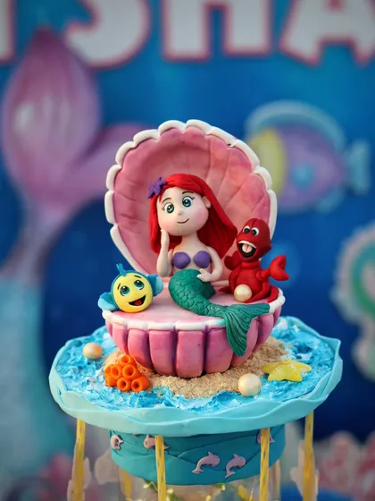 Another angle of the intricate Ariel, Flounder, and Sebastian topper.