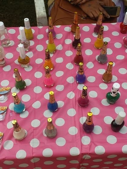 Our nail art table, showcasing a huge selection of colors on a fun polka-dot tablecloth. It's an inviting setup for any party.