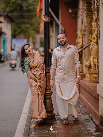 A playful moment on a city street, with her peeking out from behind a lamppost.