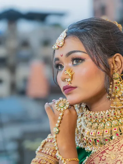 A close-up shot of the Maharashtrian bride, focusing on the intricate details of her nath and the flawless makeup application around the eyes and lips.