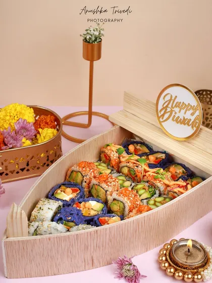 A creative fusion for Diwali: a boat-shaped wooden platter filled with colourful sushi. This image shows how I can style unconventional products for festive occasions.