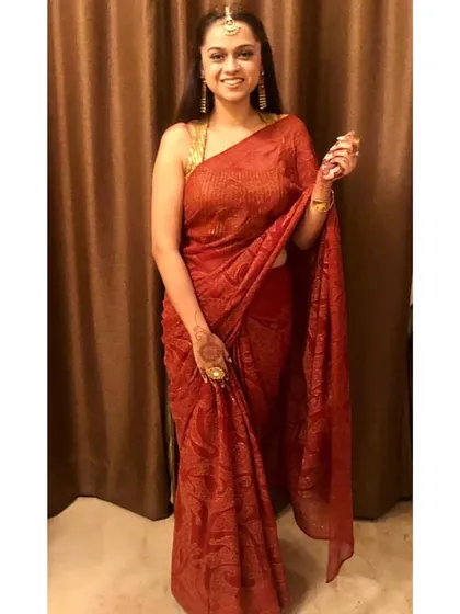 You can never go wrong with the timeless elegance of a saree. This beautiful red saree drapes gracefully to flatter the body, making it a perfect choice for a formal wedding event or festive occasion.
