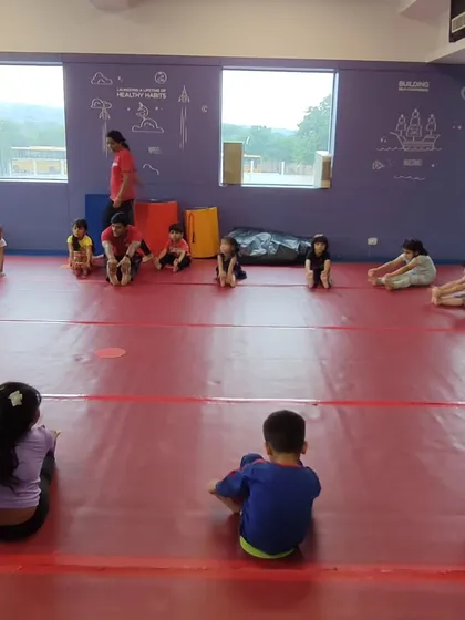 A wide view of our preschool class during stretching. This shows the spaciousness of our gym and the organized structure of our sessions.