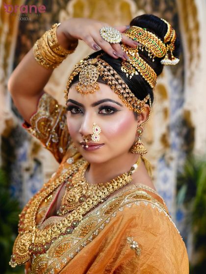 A graceful pose that highlights the elaborate head jewelry and the classic, elegant makeup style.