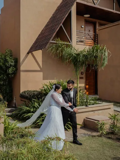 A beautiful portrait of a couple in love, set against the rustic architecture of their wedding venue in Gir. The natural light and setting add to the romance.