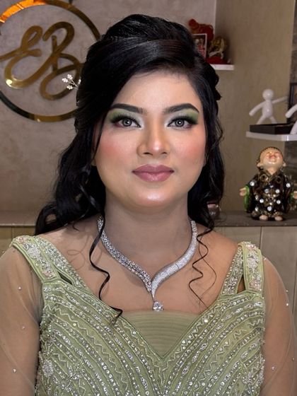 The final look, where the client looks confident and ready for her event with her unique green eye makeup.