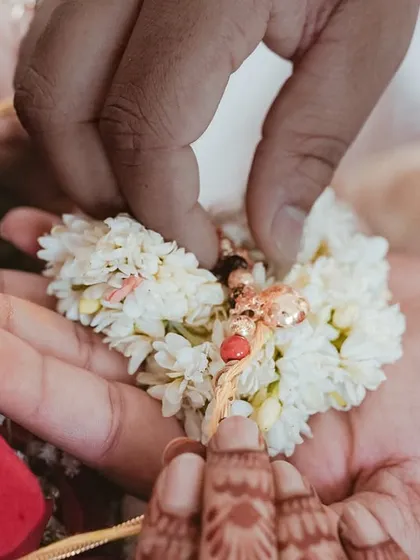 A close-up of the 'Kanyadaanam' ritual, where the bride's hands are placed in the groom's. This detailed shot focuses on the sacredness of the tradition.