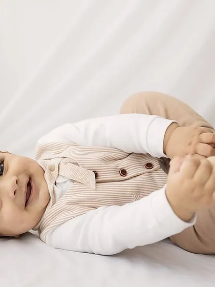 Another adorable shot of the baby playing with his feet.