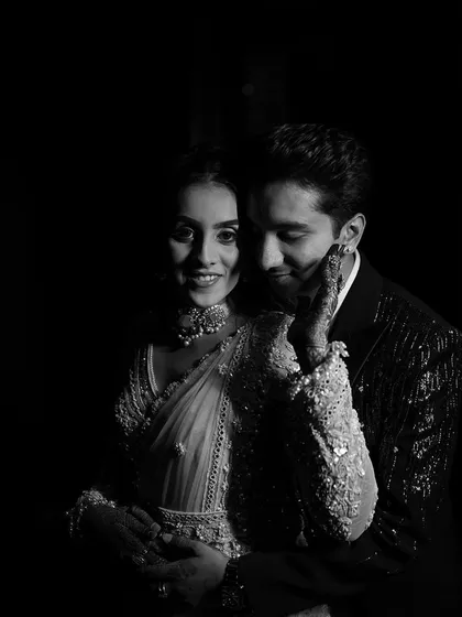 A beautiful, intimate black and white portrait. This artistic shot highlights the bride's glowing makeup and the connection between the couple.