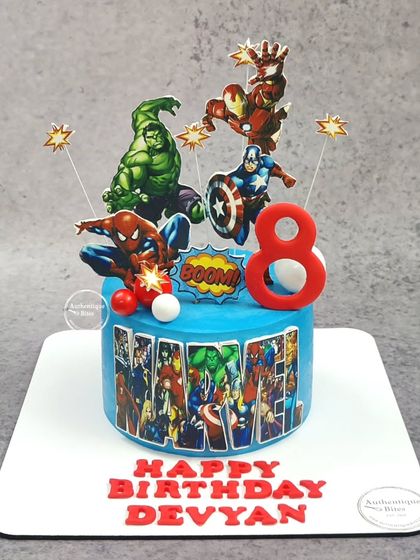 An action-packed, non-fondant Avengers cake for a young superhero. This cake brings together Hulk, Iron Man, Captain America, and Spiderman in a dynamic scene, ready to save the day.